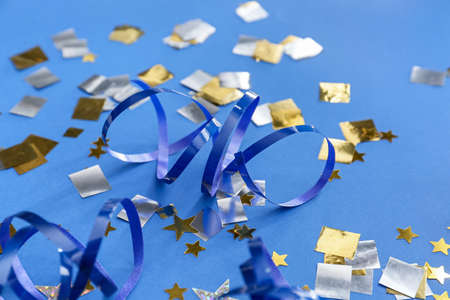 Ribbons and confetti on color background, closeup