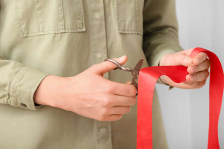 Woman cutting red ribbon, closeupの写真素材