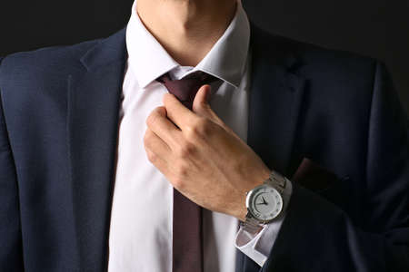 Young man in stylish suit on dark background, closeupの写真素材