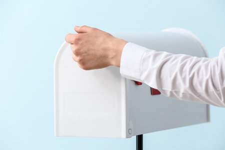 Woman with mail box on color backgroundの写真素材