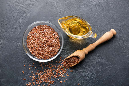 Gravy boat with flax oil and seeds on dark backgroundの写真素材