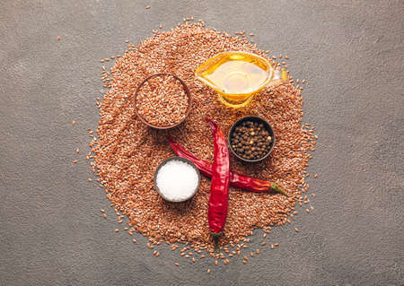 Composition with flax seeds, oil and spices on dark backgroundの写真素材