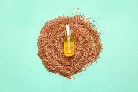 Composition with flax seeds and oil on color backgroundの写真素材