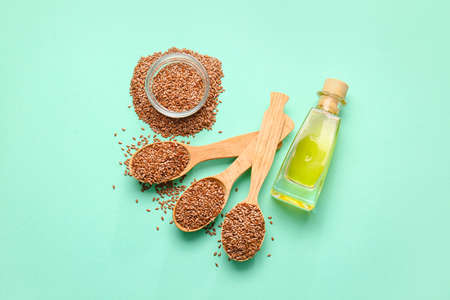 Composition with flax seeds and oil on color backgroundの写真素材
