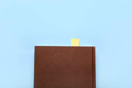 Book with bookmark on color background