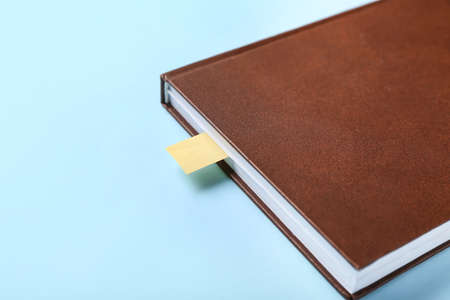 Book with bookmark on color background