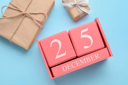 Calendar with date of Christmas and gift boxes on blue backgroundの写真素材