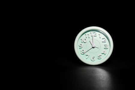 Alarm clock on black background