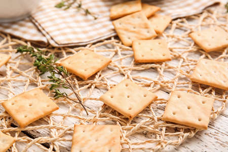 Tasty crackers on light wooden background, closeupの写真素材