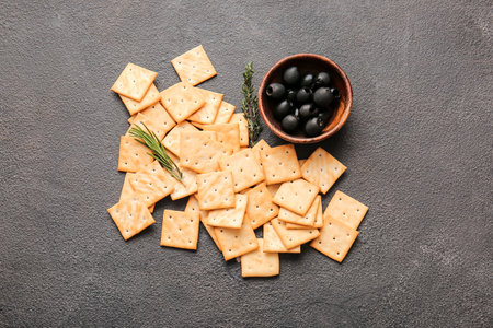 Tasty crackers and olives on dark backgroundの写真素材