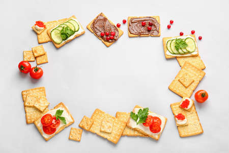 Frame made of tasty crackers on gray backgroundの写真素材