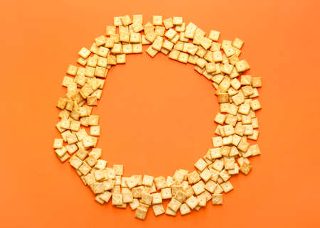 Frame made of tasty crackers on color backgroundの写真素材