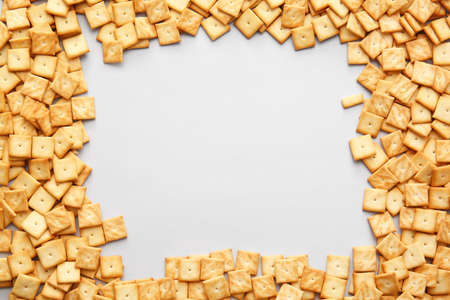 Frame made of tasty crackers on gray backgroundの写真素材