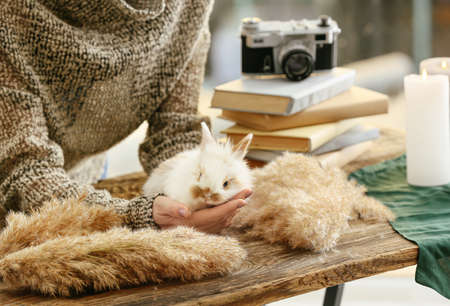 Woman with cute rabbit at home