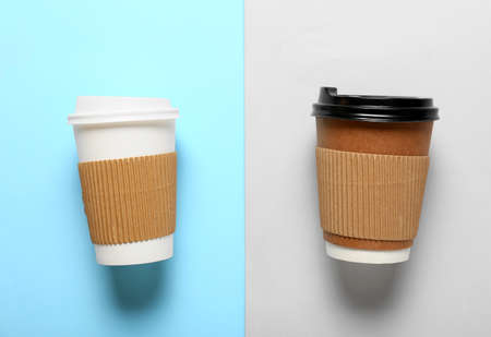 Takeaway cups for coffee on color background
