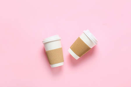 Takeaway cups for coffee on color backgroundの写真素材