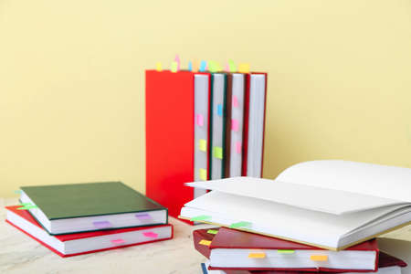 Many books with bookmarks on table