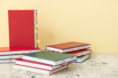 Many books with bookmarks on table