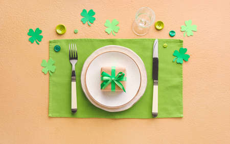 Beautiful table setting for St. Patrick's Day celebration on color backgroundの写真素材
