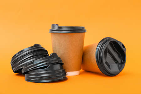 Takeaway cups for coffee on color backgroundの写真素材