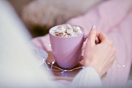 Beautiful young woman drinking hot chocolate at home, closeupの写真素材