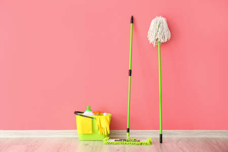 Set of cleaning supplies near color wallの写真素材