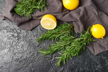 Fresh rosemary and lemons on dark backgroundの写真素材