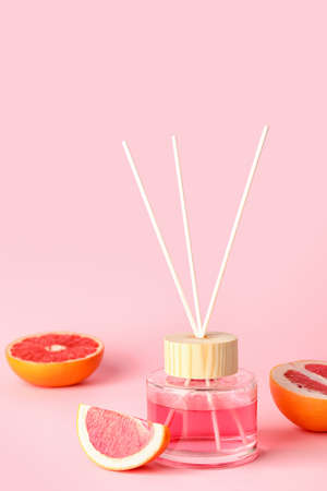 Reed diffuser with grapefruits on color backgroundの写真素材