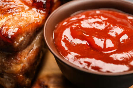 Bowl with tasty barbecue sauce and grilled pork, closeupの写真素材