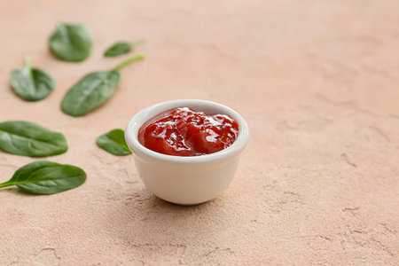 Bowl with tasty barbecue sauce on color backgroundの写真素材