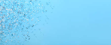 Beautiful confetti on blue background with space for textの写真素材