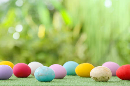 Beautiful Easter eggs on grass outdoorsの写真素材