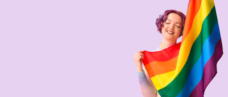 Young woman with LGBT flag on color background with space for textの写真素材