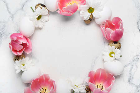 Composition with Easter eggs and spring flowers on light backgroundの写真素材