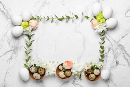 Composition with Easter eggs and spring flowers on light backgroundの写真素材