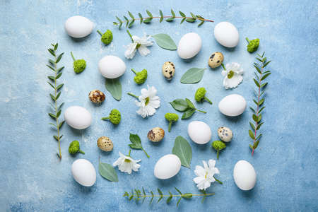 Composition with Easter eggs and spring flowers on color backgroundの写真素材