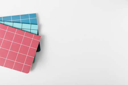 Checkered notebooks on white background
