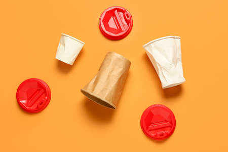 Crumpled blank paper cups on color backgroundの写真素材