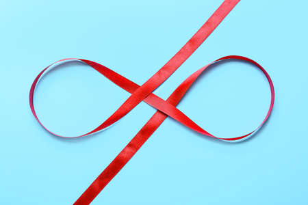 Red ribbon on color backgroundの写真素材