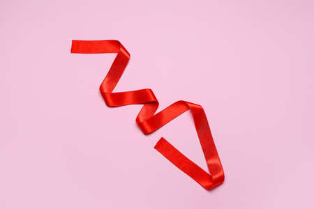 Red ribbon on color backgroundの写真素材