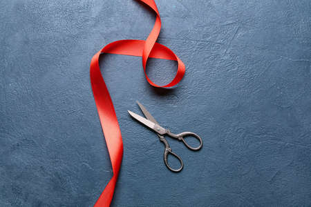 Red ribbon and scissors on dark backgroundの写真素材