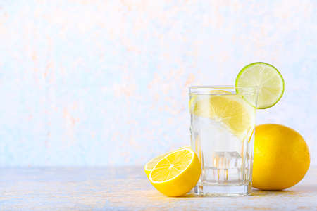 Glass of tasty cold lemonade on light backgroundの写真素材