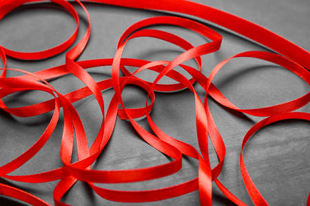 Red ribbons on dark background, closeupの写真素材