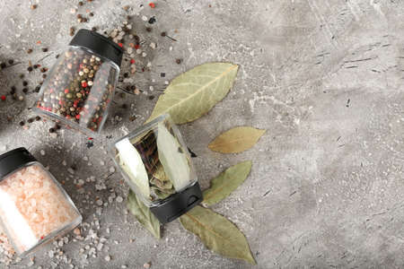 Jars with different spices on grunge background