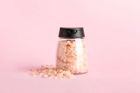 Jar with sea salt on color backgroundの写真素材