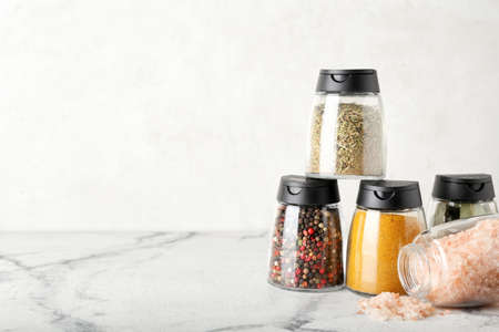 Jars with different spices on light backgroundの写真素材