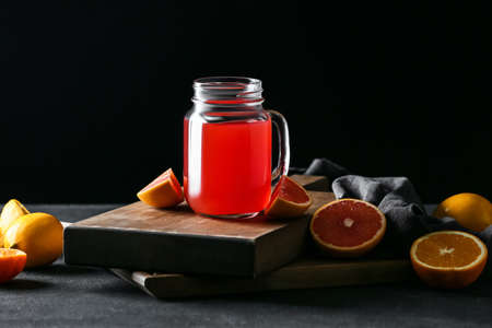 Mason jar of grapefruit juice on dark backgroundの写真素材