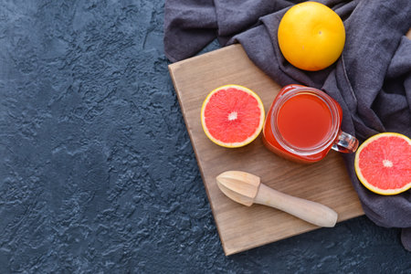 Mason jar of grapefruit juice on color backgroundの写真素材
