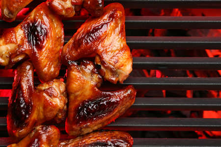 Roasted chicken wings cooking on grill