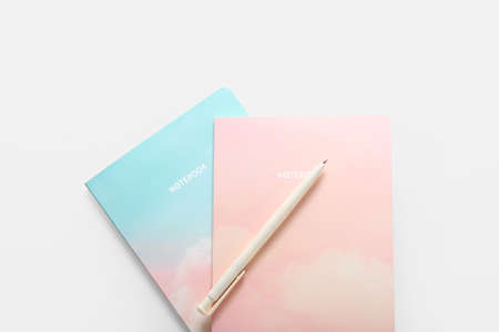 Stylish notebooks and pen on white backgroundの写真素材
